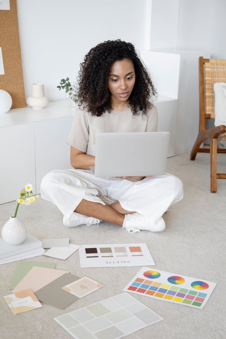 Woman in White T-shirt Sitting on Chair Using Macbook